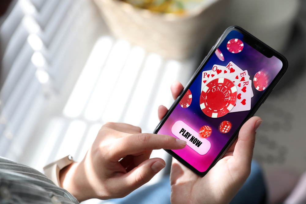 Woman,Playing,Online,Poker,On,Mobile,Phone,Indoors,,Closeup